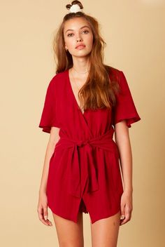 Burgundy Romper. Every day spent in the Falling For You Burgundy Romper will be absolutely exceptional! Burgundy woven fabric shapes a plunging neckline and surplice bodice, framed by wide, short flutter sleeves. Matching, attached skort has flattering asymmetrical hem on front and rounded hem on back. Elasticized waist with tying sash and back zipper/clasp closure. Burgundy Weave, Burgundy Tie, Boho Pink, Boho Romper, Boho Boutique, Careless Whisper, Pink Boho, Romper Dress, Bohemian Clothes