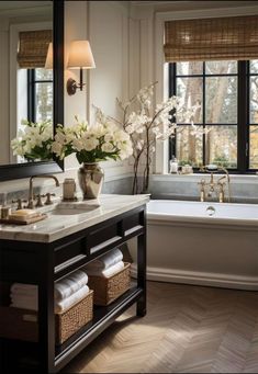 a bathroom with a tub, sink and mirror in it's centerpieces