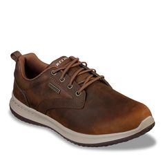 Enhance your everyday look with these men's Skechers brown Delson Antigo sneakers. Designed using a leather upper with a waterproof seam sealed design, these oxford-inspired sneakers feature a round toe front, slip-on design with a stretch laced front panel, padded collar and tongue, soft fabric lining, Air Cooled Memory Foam comfort insole, lightweight shock absorbing midsole, and a flexible outsole with incredible traction. | Skechers Men's Waterproof Delson Antigo Casual Oxford in Brown Size Semi-formal Brown Oxfords With Cushioned Footbed, Rugged Brown Slip-resistant Walking Shoes, Brown Leather-lined Slip-on Oxfords, Masculine Leather Slip-on Oxfords, Brown Goodyear Welted Slip-on Oxfords, Mens Skechers, Skechers Shoes, Seal Design, Mens Oxfords