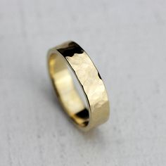 a close up of a gold ring on a white surface