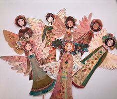 paper cut outs with angels and flowers on them, all in different shapes and sizes