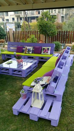 some purple and green benches in the grass