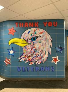 a sign that says thank you veterans with an eagle and stars painted on the wall