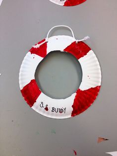 a paper plate life preserver is hanging on the wall