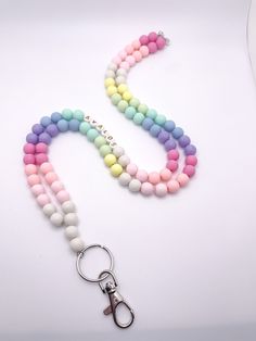 These gorgeous lanyards are made with 10mm beads. We use high quality bead wire which allows you to move throughout your day without worrying about the strength of your lanyard. Each lanyard is 34 inches long, includes a keyring and lobster claw, and can be personalized to include your name or any other saying. You can choose from four different bead colors for personalization and add on a tassel too! ⭐️if you prefer your lanyard to be short or longer send me a message and we can accommodate. ⭐️ Pink Round Beads Necklace For Personal Use, White Lanyard With Colorful Beads For Gifts, White Lanyard With Colorful Beads As Gift, Multicolor Personalized Lanyards With Round Beads, Personalized Multicolor Lanyards With Round Beads, Colorful Round Beads Necklace, Gift Beaded Chain Lanyard, Multicolor Round Bead Jewelry For Personal Use, Handmade Pink Beaded Lanyards