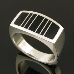 a silver ring with black stripes on it