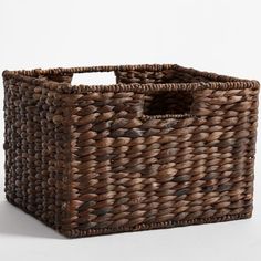 a brown woven basket with handles on a white background and the bottom section is empty