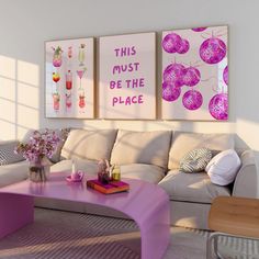 a living room filled with furniture and paintings on the wall above it's coffee table