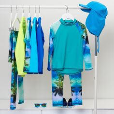 Our Tropical print is a favorite with our clients. There are so many items available in this print, ranging in sizes from 12 months up to 14-16Y Head over to our site now to check them all out! Tropical Horizon Long Sleeve Rash Guard #sunpoplife #sunprotectionclothing #rashguard #rashguards #sunprotectiveclothing #sunsafety #kidsrashguards #longsleeverashguards #kidsbeachwear #kidsswimwear #sunprotection Playful Blue Rash Guard For Pool, Playful Blue Swimwear For Water Sports, Playful Stretch Swimwear With Upf 50+, Playful Summer Rash Guard With Uv Protection, Playful Rash Guard With Uv Protection For Beach Season, Playful Rash Guard With Uv Protection For Summer, Blue Rash Guard With Uv Protection For Beach Season, Playful Blue Rash Guard With Uv Protection, Green Fitted Rash Guard For Beach Season