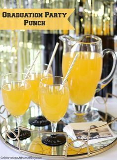 two glasses of orange juice on a tray with the words graduation party punch in front of them