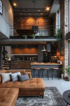 a living room filled with furniture next to a kitchen and loft style home office area