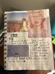 a hand holding up a notebook with pictures and words written on the pages in it