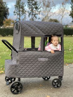 a baby in a stroller that is on the ground