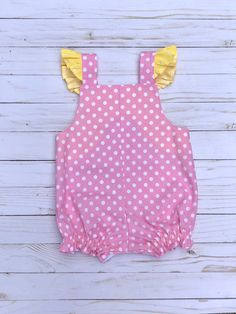 This You are my sunshine First Birthday Romper is the perfect romper for your little ones first birthday. The romper is made with a pink and white polka dot fabric with coordinating yellow polka dot accents. It has a sun appliqué with a #1 balloon. It can be personalized with a name. Please include the name and date needed by in the message to seller when you checkout. Pink Sleeveless Bubble Romper For First Birthday, Pink Cotton Fun Bubble Romper, Pink Cotton Bubble Romper In Fun Style, Cute Yellow Bubble Romper With Ruffles, Lemonade First Birthday, Birthday Outfit Pink, Sunshine First Birthday, Birthday Romper, 1 Balloon