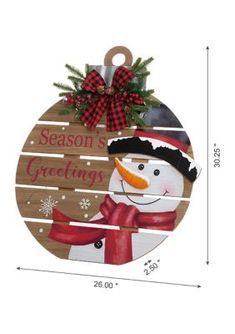 a wooden ornament with a snowman on it and the words season greetings