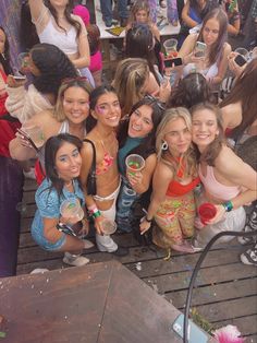 a group of young women standing next to each other on a wooden floor covered in confetti