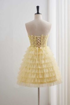 This homecoming dress features a stylish A-line silhouette crafted from high-quality yellow tulle material. The top is adorned with delicate lace appliques, while the skirt boasts tiered ruffles. The neckline is a sweetheart style and the back can be tied with a lace-up closure. Perfect for any occasion, this dress falls above the knee for a chic and sophisticated look. Item #NP1107 Material: Tulle Color: Yellow Silhouette: A-line Embellishment: Lace appliques top, tiered ruffle skirt Neck: Swee Tulle Material, Tiered Ruffle Skirt, Short Homecoming Dress, Ruffle Shorts, Silhouette Crafts, Lace Applique, Above The Knee, Fall Dresses, Homecoming