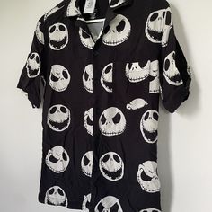 a black shirt with jack skellingy faces on it