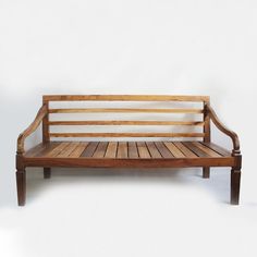 a wooden bench sitting on top of a white floor