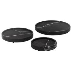 three black marble coasters sitting on top of each other