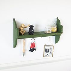 there is a shelf with two teddy bears on it and other items hanging from hooks