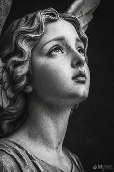 black and white photograph of a statue of an angel with her head turned to the side