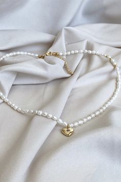 White Rice pearl Choker, dainty gold-plated charm necklace. Old Money jewelry by MarinaMiJewelry. Freshwater pearls, coquette jewelry gift for mom. Take a look at my coquette jewelry Freshwater pearl choker necklace, featuring a delicate star, cross or heart charms. An ode to the old-money aesthetic jewelry, this pearl drop necklace is crafted from lustrous rice pearls and 18K gold-plated brass, ensuring a nickel-free, premium accessory. Old Money Necklace Aesthetic, Elegant Gold Beaded Necklaces For Valentine's Day, Gold Heart Beads Choker Necklace, White Choker Necklace For Valentine's Day, Gold Heart Beads Choker Jewelry, Gold Heart-shaped Pearl Beaded Necklaces, Gold Heart Beaded Choker Jewelry, Gold Heart-shaped Pearl Beaded Necklace, Minimalist Beaded Necklace With Pearl Charm As Gift