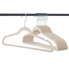 three wooden hangers on a black rail and one white hanger is hanging from the ceiling