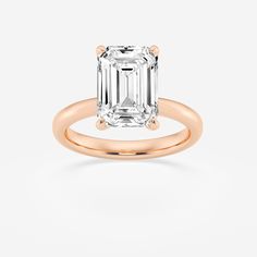 an emerald - cut diamond engagement ring with two clawed shans, set in 18k rose gold