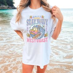 If you're a coconut girl looking for trendy summer clothes, then you've come to the right place! We have a great selection of beachy tees, surf shirts, and summer tees that will keep you looking stylish and on-trend all summer long. Our Comfort Colors Skeleton Surf Beach shirt is perfect for beach days and summer hangouts. * Ultra soft * Distressed design * Pre-shrunk * Universal fit * True to size * DTG Printing * Brand - Comfort Colors Refunds/Exchanges: * No Cancellations * No returns/exchanges * All sales are final Sizing: Our graphic tees and sweatshirts are a true to size standard unisex fit. For an oversized look, please size up. For a TShirt dress fit, we recommend sizing up at least two sizes. Please oversee the sizing chart provided in the listing photos to ensure your measuremen Beachy Tees, Barbie Sweatshirt, Summer Tees, Halloween Tshirt, Sun Shirt, Coconut Girl, Trendy Summer Outfits, Spooky Vibes, Beach Shirt