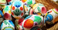 many colorful painted eggs in a basket