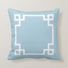 a light blue and white greek key design pillow on a beige linen background with the text sky blue and white greek key designs