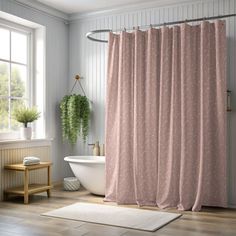 a bathroom with a bathtub, sink and shower curtain in pink colors on the wall