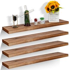 three wooden shelves with flowers and other items on them in front of a white background