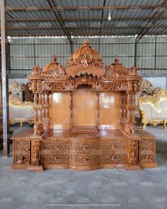 an elaborately carved wooden bed in a warehouse