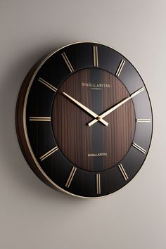 a black and gold clock with roman numerals on the face that says singularita