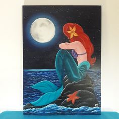 a painting of a mermaid sitting on top of a rock