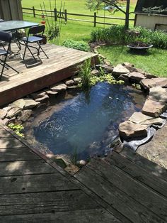 a small pond in the middle of a wooden deck