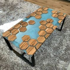 a coffee table made out of wood and glass with hexagon tiles on it