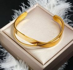 This bangle is doubly cool and perfect for everyday wear. Featuring two layers of gold, it's sure to make a stylish statement. Trendy Adjustable Gold Plated Cuff Bracelet, Chic Gold Cuff Bangle, Trendy Gold-plated Bangle For Gift, Chic Gold Plated Bangle As A Gift, Gold Double Band Adjustable Bracelets, Gold Adjustable Double Band Bracelet, Trendy Gold Bangle Cuff Bracelet, Gold Double Band Bracelets For Formal Occasions, Chic Gold Plated Cuff Bracelet