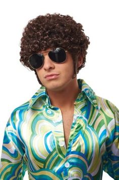 a man with curly hair and sunglasses on his head wearing a shirt that has an abstract pattern