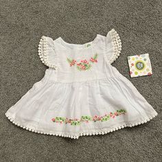 Never Worn Adorable Baby Girl Dress. Cute Trim And Embroidery Details And Button Down Back. Summer Floral Embroidered Playtime Dress, Cute Cotton Embroidered Spring Dress, Cute Spring Embroidered Cotton Dress, Floral Embroidered Summer Dress For Playtime, Summer Floral Embroidery Dresses For Playtime, Playful White Embroidered Dress, Cotton Dress With Floral Embroidery For Playtime, Spring Floral Embroidered Dress For Playtime, Cute Floral Embroidery Dress For Playtime