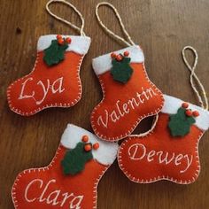 three christmas stockings ornament hanging on a wooden table with red and white stocking