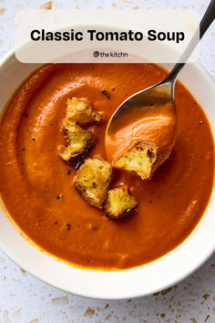 a bowl of tomato soup with bread croutons in it and the title classic tomato soup