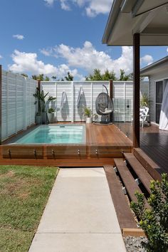 a backyard with a pool and decking area