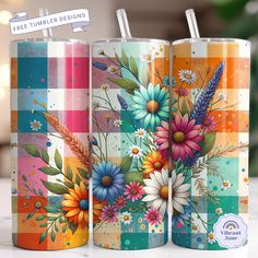 two colorful tumbles with floral designs on them