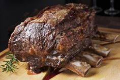 a large piece of meat sitting on top of a wooden cutting board