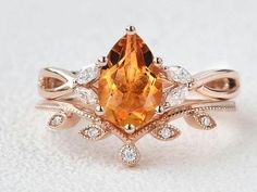 an orange and white diamond ring with leaves on it