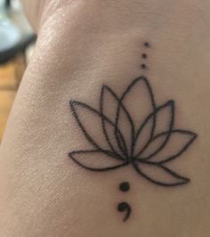 a lotus tattoo on the back of a woman's arm