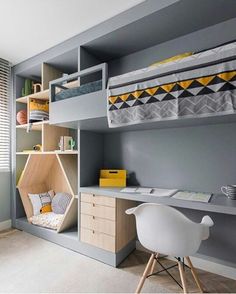 a bedroom with bunk beds, desk and shelves